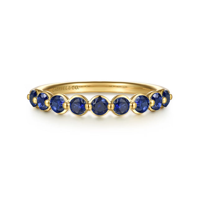 A yellow gold  ring featuring nine round-cut blue sapphire gemstones, shown on a clean white background. The brand name 'GABRIEL &amp; CO.