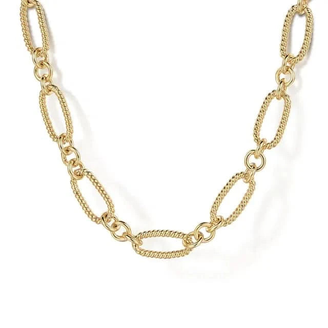 Gold chain necklace on a white background close up