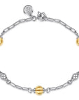 Bracelet with gold and silver beads on a white background