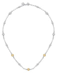 Silver necklace with small gold beads on a white background