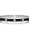 A two-tone stretch bracelet featuring a black enamel central section with gold beaded accents, flanked by silver-toned round beads on each end.