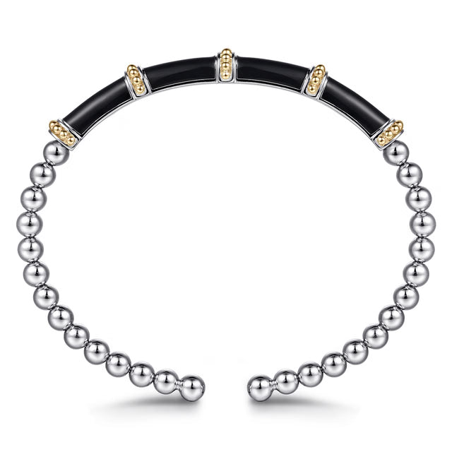 A two-tone beaded bangle bracelet featuring a black inlay section and a silver-toned beaded section on a white background. side view