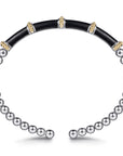A two-tone beaded bangle bracelet featuring a black inlay section and a silver-toned beaded section on a white background. side view