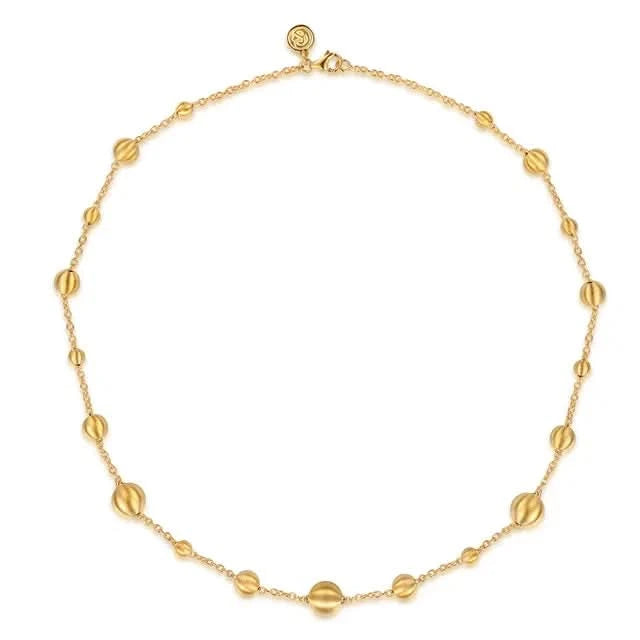 Gold necklace with round beads on a white background