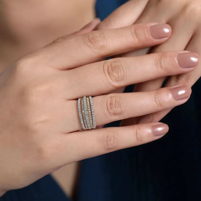 Hand wearing a stacked  diamond ring with a blurred background