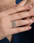 Hand wearing a stacked  diamond ring with a blurred background