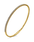A 14k yellow gold rigid oval bangle bracelet from the 1.01 carat variant option, featuring a delicate single row of round brilliant-cut diamonds set halfway across the top bar.