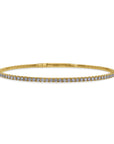 A 14k yellow gold rigid oval bangle bracelet from the 1.01 carat variant option, featuring a delicate single row of round brilliant-cut diamonds set halfway across the top bar. front view