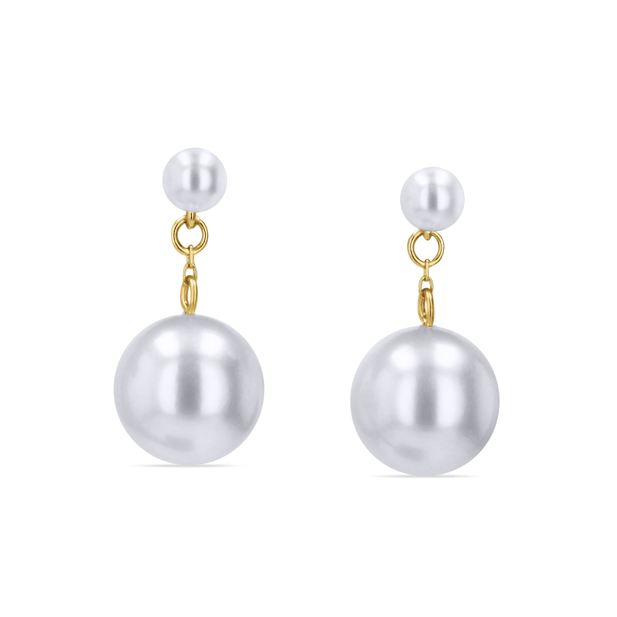 A pair of 14k yellow gold graduated drop earrings by ASBA, showcasing a small 3.5mm pearl stud connected by fine gold loops to a large, dangling 8.5mm white pearl.