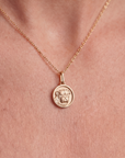 Gold chain with bulldog medallion on a person's neck