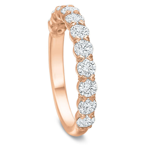 A rose gold ring featuring a row of round brilliant-cut clear gemstones set in a polished band, shown on a clean white background.