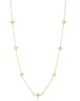 Gold necklace with flower shaped stations on a white background