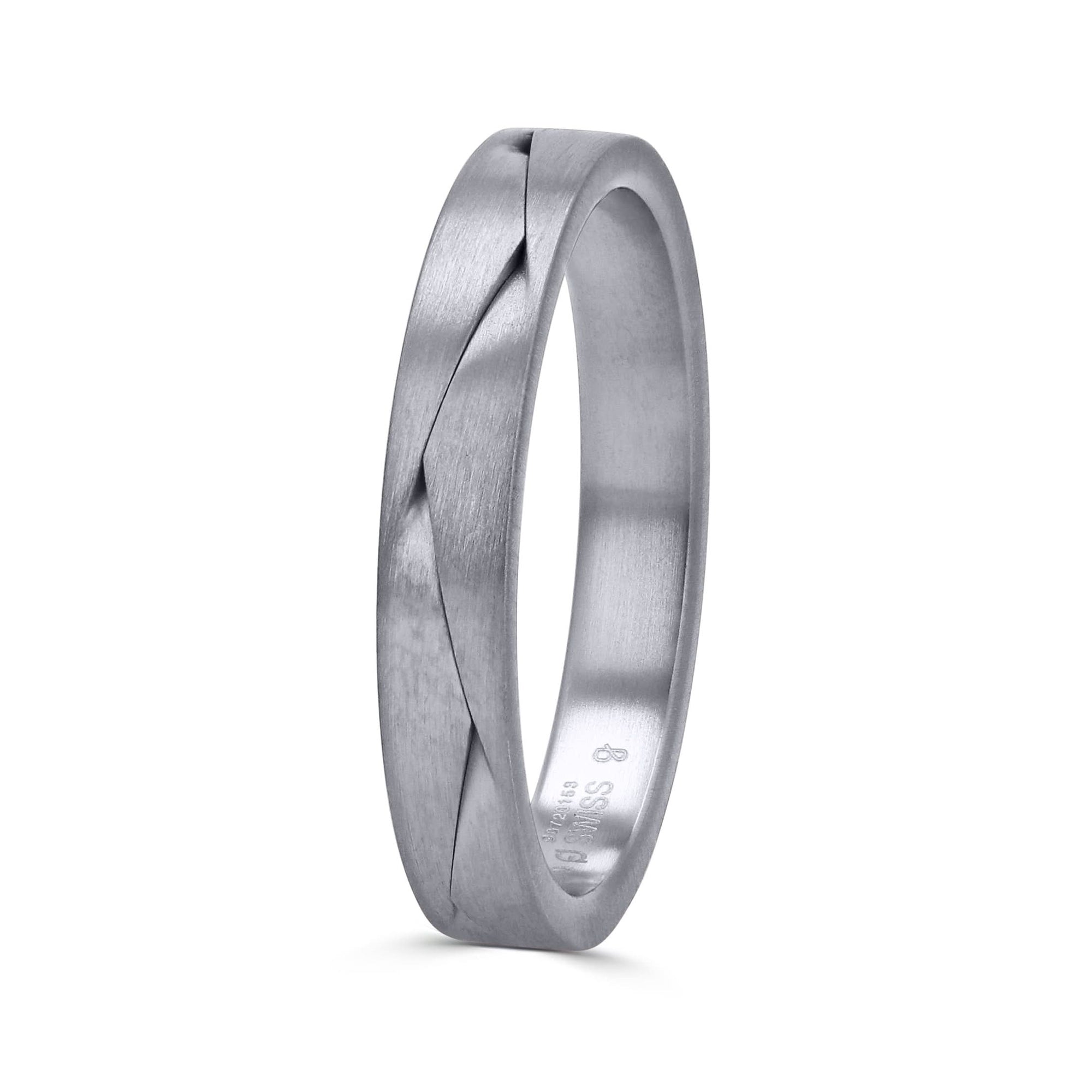 A 3.5mm wedding band by Furrer Jacot, crafted in solid 18k white gold with an architectural, sculpted overlapping braid pattern finished in a fine matte brushed texture. at an upright angled view