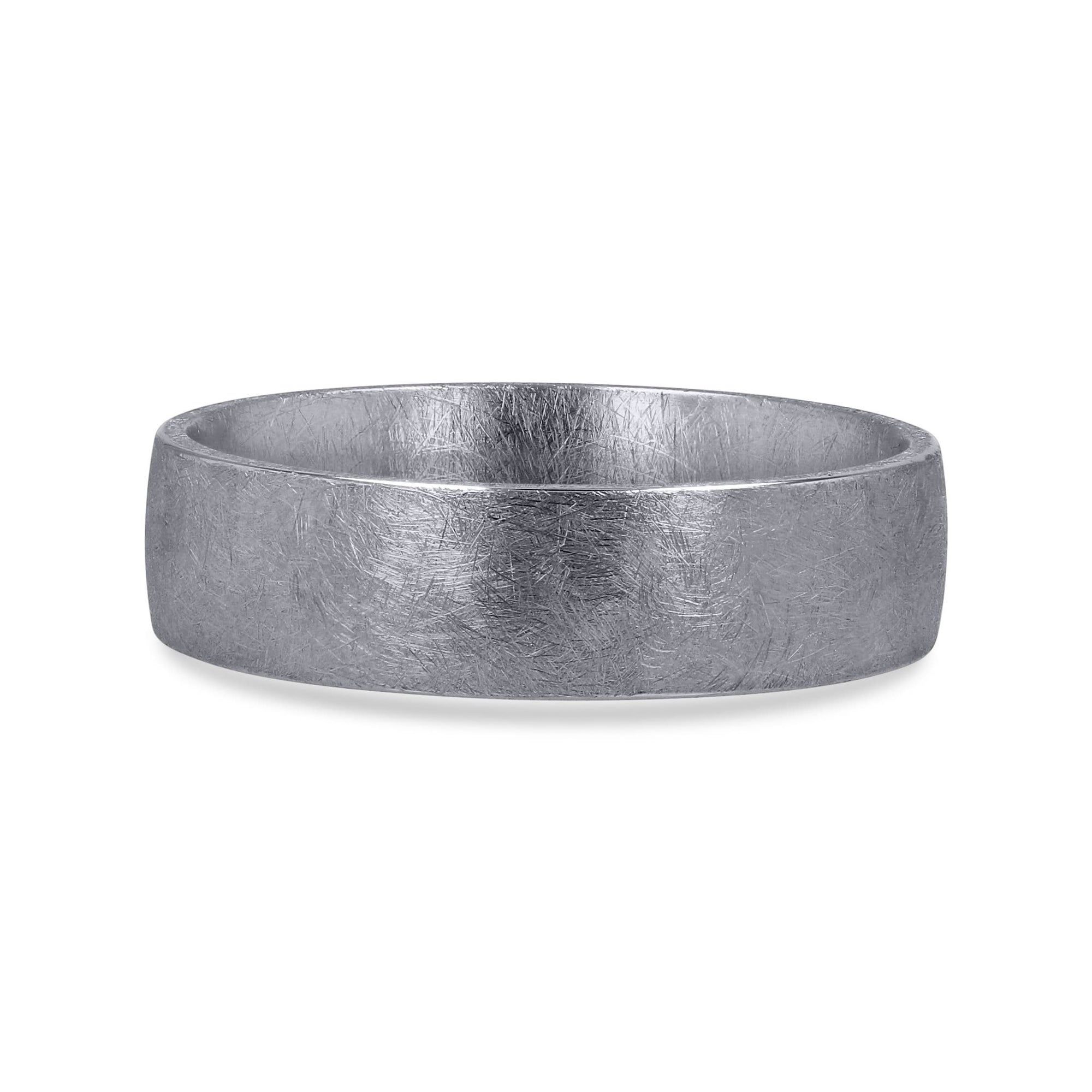 A 6mm men's wedding band by Furrer Jacot, crafted in solid 18k white gold and showcasing a distinctive, multi-directional matte brushed finish with an intricate cross-hatched texture.