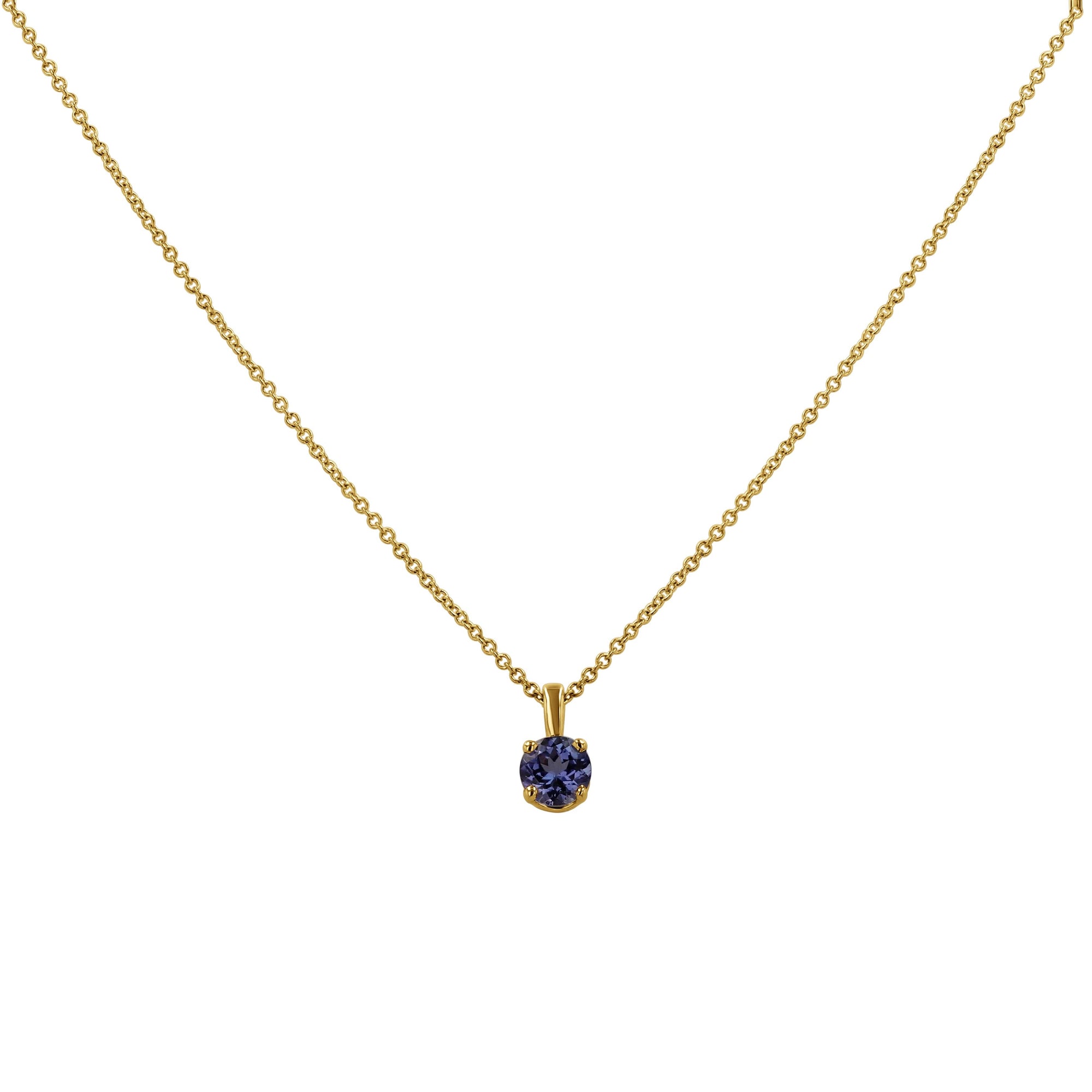 An 18k yellow gold solitaire pendant necklace by Skeie's Jewelers, featuring a 0.55 carat, 5mm round brilliant-cut blue tanzanite gemstone secured in a four-prong basket setting on an 16-inch gold cable chain.