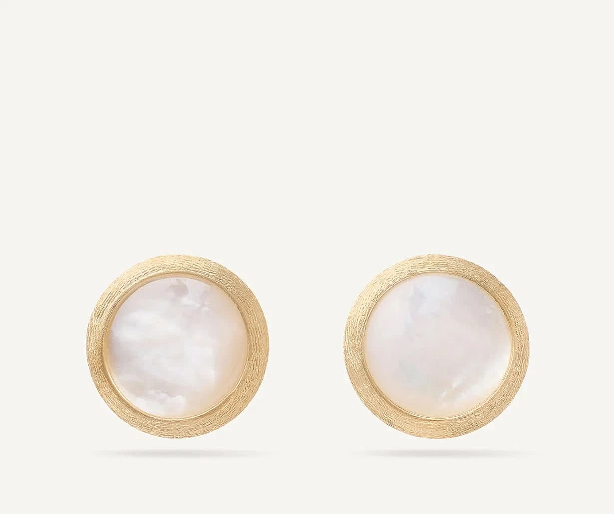 Pair of gold earrings with round white mother of pearl stones on a white background