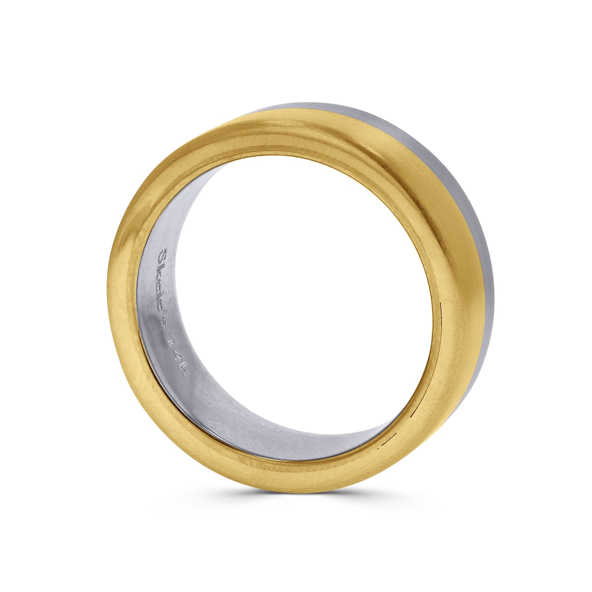 Gold and silver ring on a white background side profile view