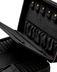 An open black jewelry organizer case with gold-tone zippers and snaps, showing interior compartments, elastic bands, and ring slots on a white background.