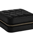 A black textured faux-leather zippered jewelry box with a quilted top, shown on a plain white background.