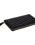 A black quilted leather zip-around clutch with a gold zipper and a black tassel pull, shown on a plain white background.