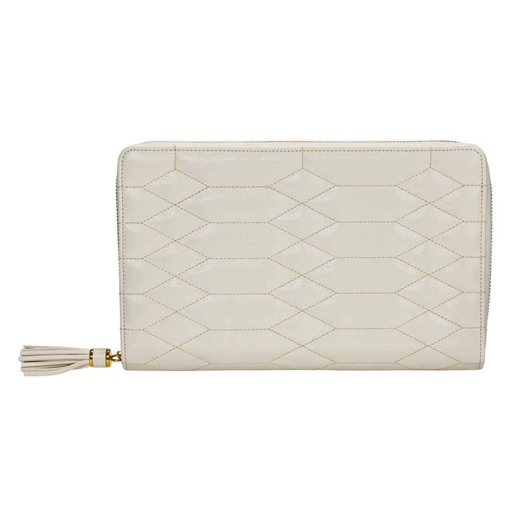 An off-white quilted zip-around wallet with a geometric diamond pattern and a matching tassel zipper pull, shown on a plain white background.