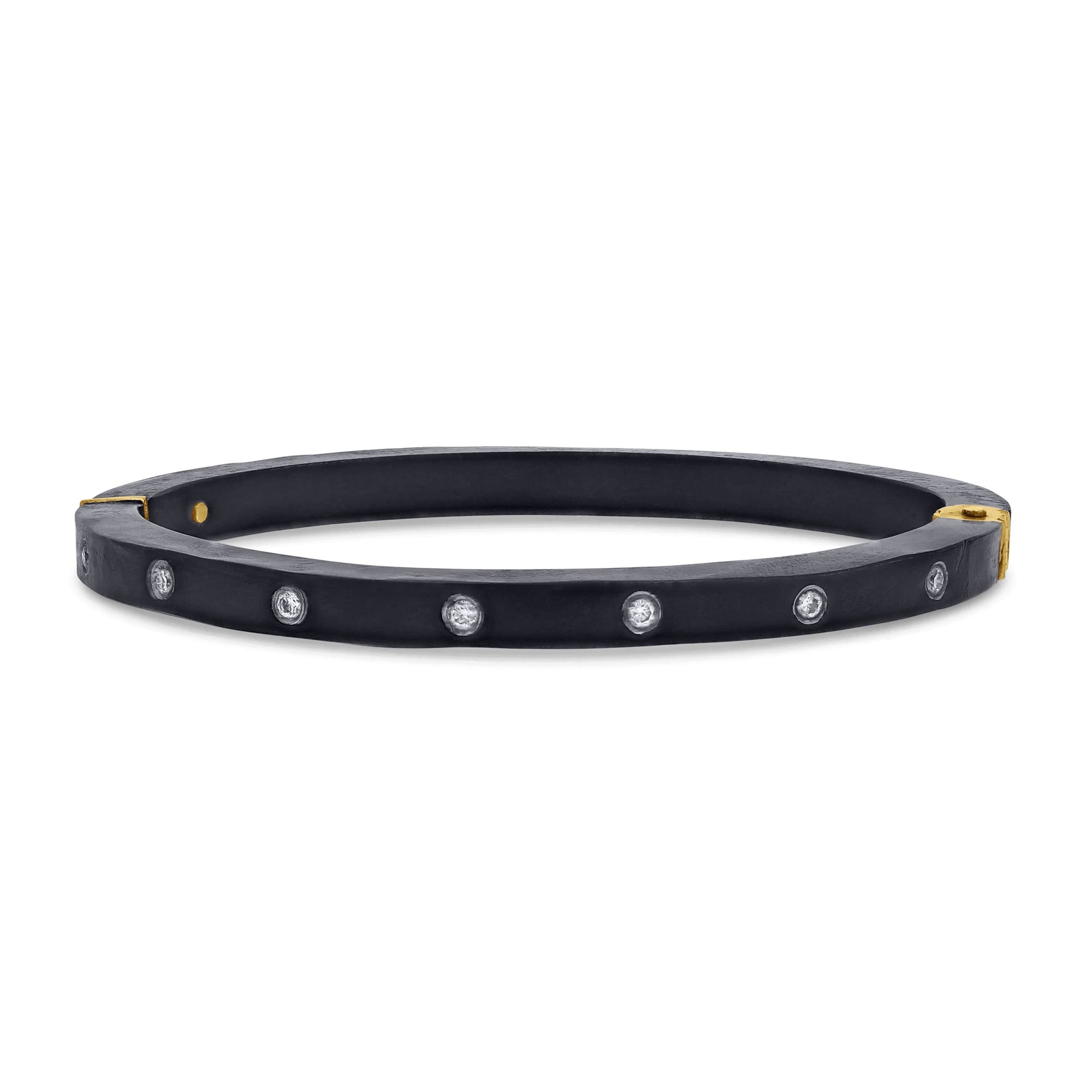Black bracelet with gold accents and embedded stones on a white background