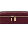 Maroon jewelry box with gold zipper on a white background