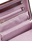 Open pink handbag with gold zippers on a white background
