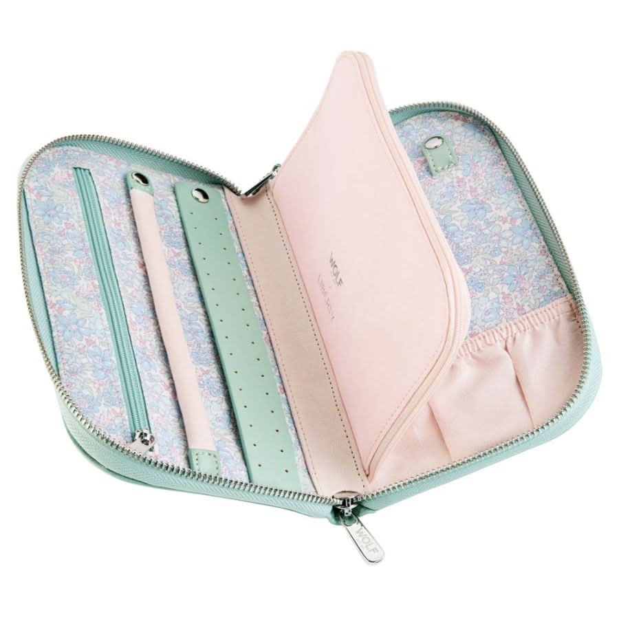 Open pastel-colored jewelry bag with floral lining on a white background