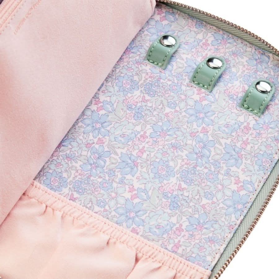 Close-up of a pink bag with floral lining and green buttons.