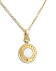 A gold pendant necklace featuring a circular disc charm with a white mother-of-pearl center, a small red gemstone accent, and a beaded outer border, suspended on a gold chain against a white background.