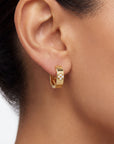 gold hoop with diamonds on a close up ear 
