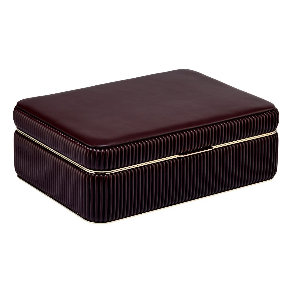 a closed maroon leather jewelry box with gold trim on a white background