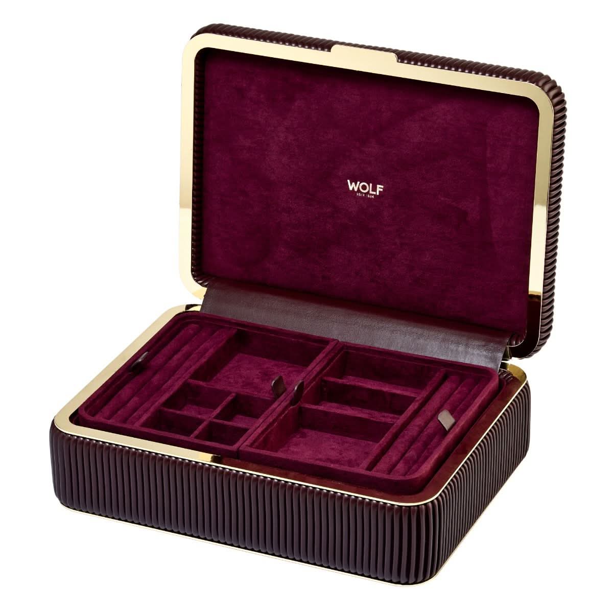 A front view of the WOLF Bella Medium Jewelry Box in a rich Bordeaux quilted leather exterior, shown open to reveal its plush cream interior lining, top organizational compartments, two lower pull-out drawers, built-in lid mirror, and polished metal lock detailing on a white background.