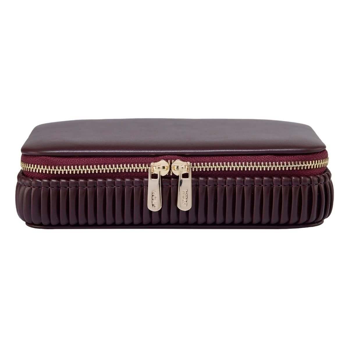 maroon travel case with gold zipper front view on a white background