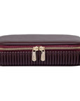 maroon travel case with gold zipper front view on a white background