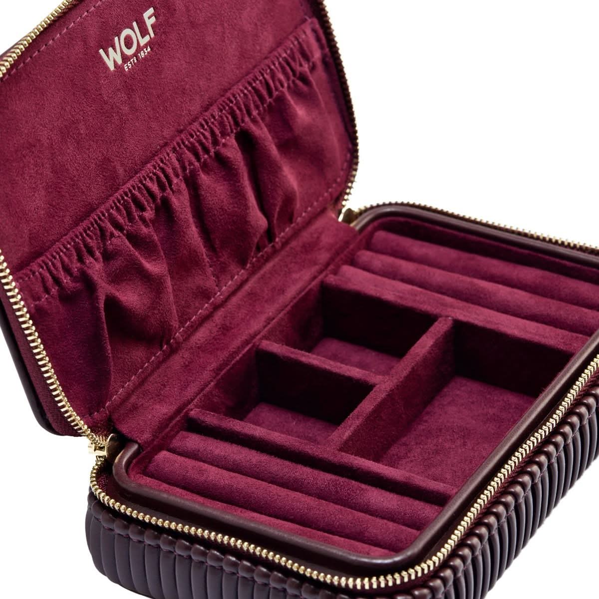 Maroon jewelry case with gold zipper and 'WOLF' branding on a white background