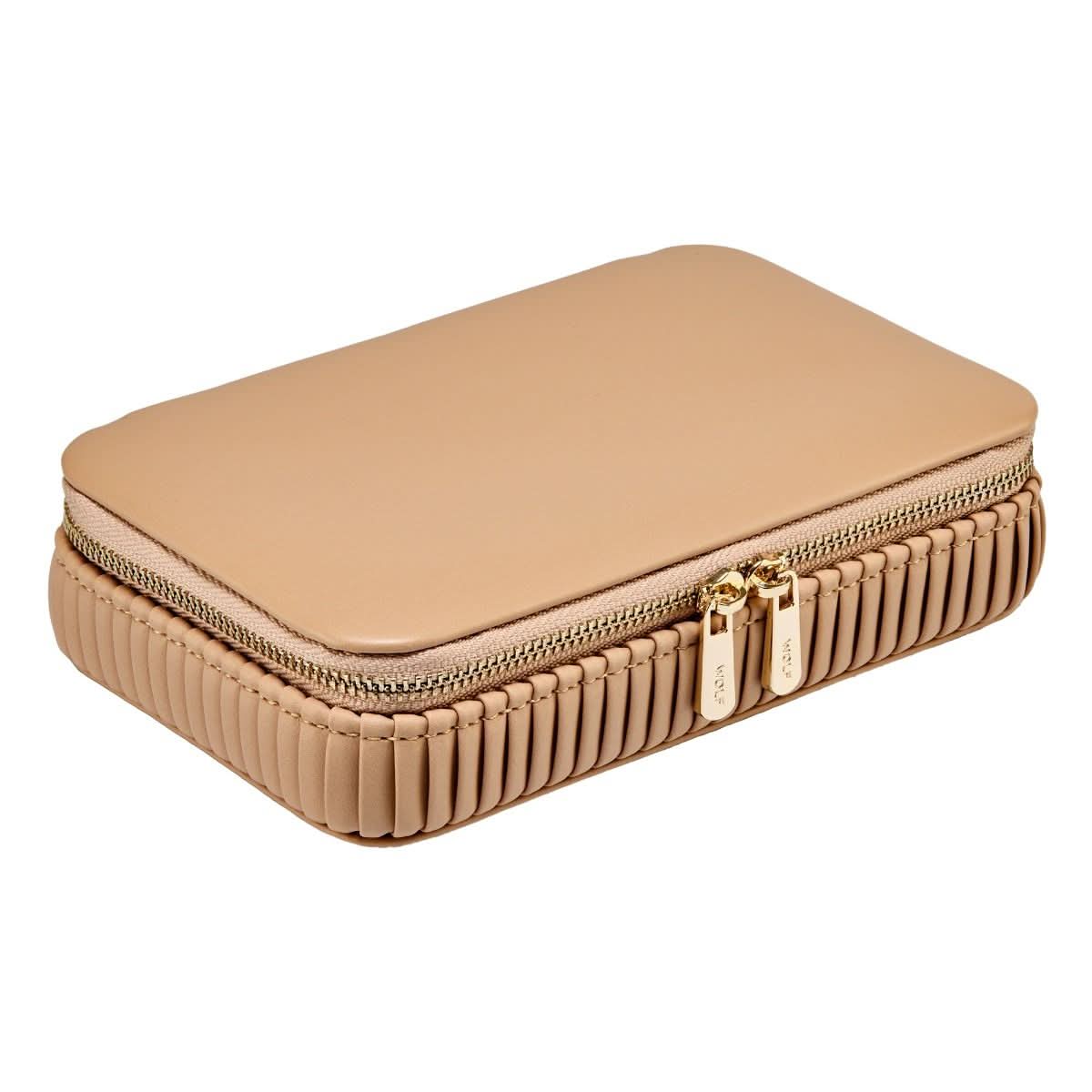 Beige jewelry case closed with gold zipper on a white background