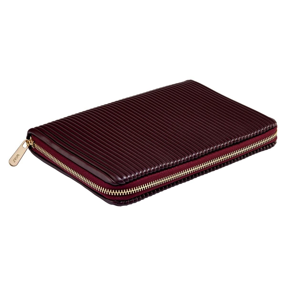 Maroon case with gold zipper on a white background