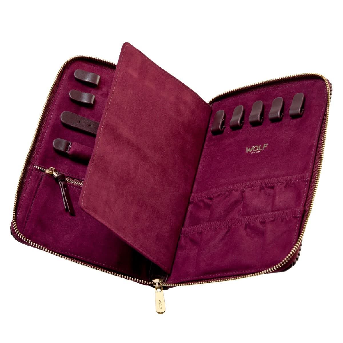 Purple jewelry case open showing holders, brand 'WOLF' visible, on a white background