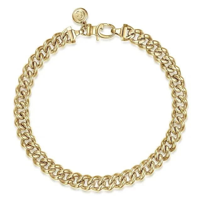 Gold curb link chain bracelet on a white background