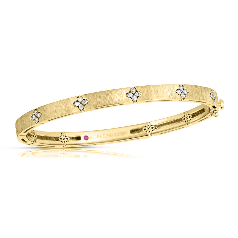 front view of the Roberto Coin Love in Verona diamond accent and satin finish gold bangle (Reference 8882971AYBAX), showcasing its oval structure, matte brushed finish, repeating four-petal floral engravings, and inset glistening white diamonds against a clean white background.