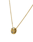 Gold necklace with a round pendant on a white background angled side view