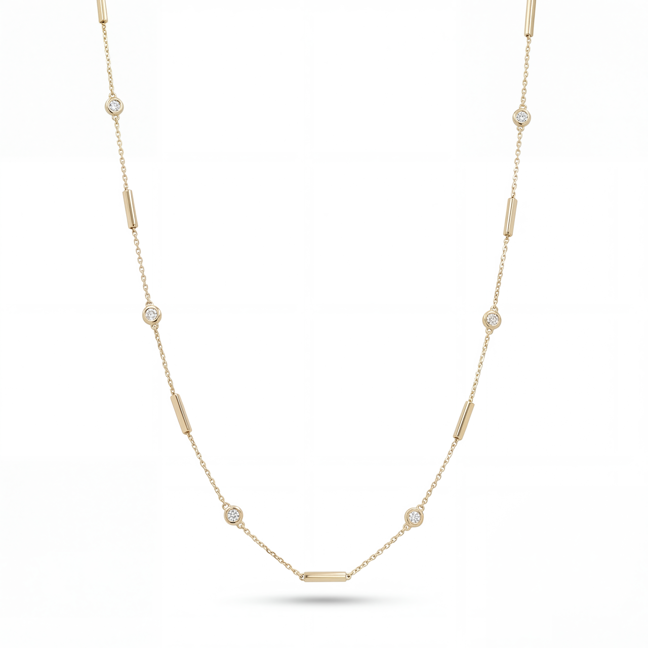 Gold necklace with small diamonds on a white background