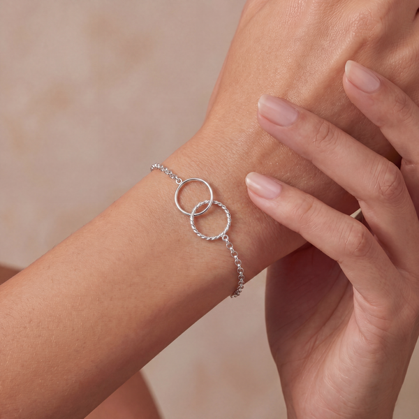 close up of arm with interlocking circles silver bracelet