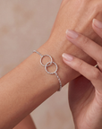 close up of arm with interlocking circles silver bracelet