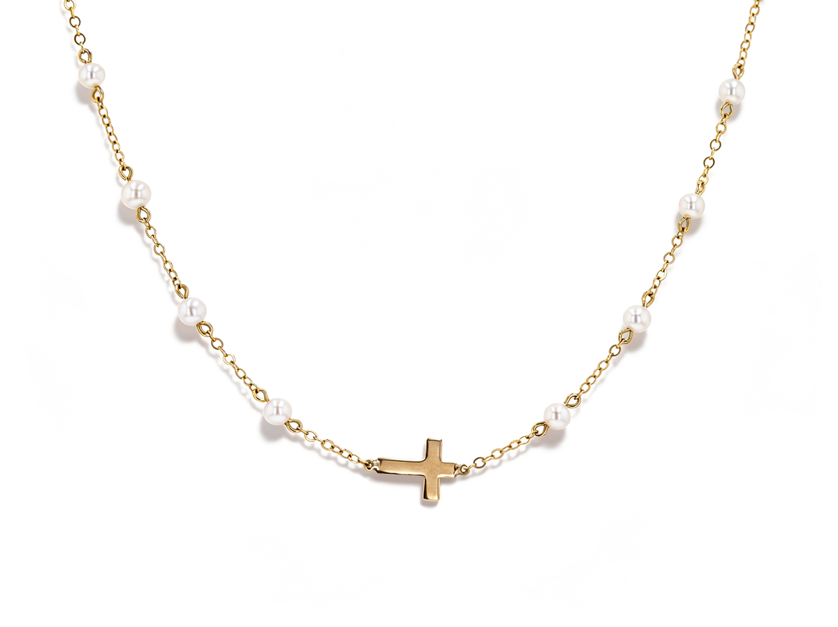 A delicate gold chain necklace featuring small white pearl beads spaced along the chain and a small gold cross pendant at the center, shown against a plain white background.