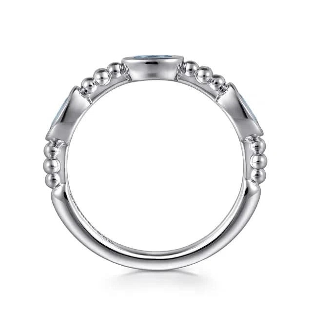 Silver ring with bead detailing on a white background