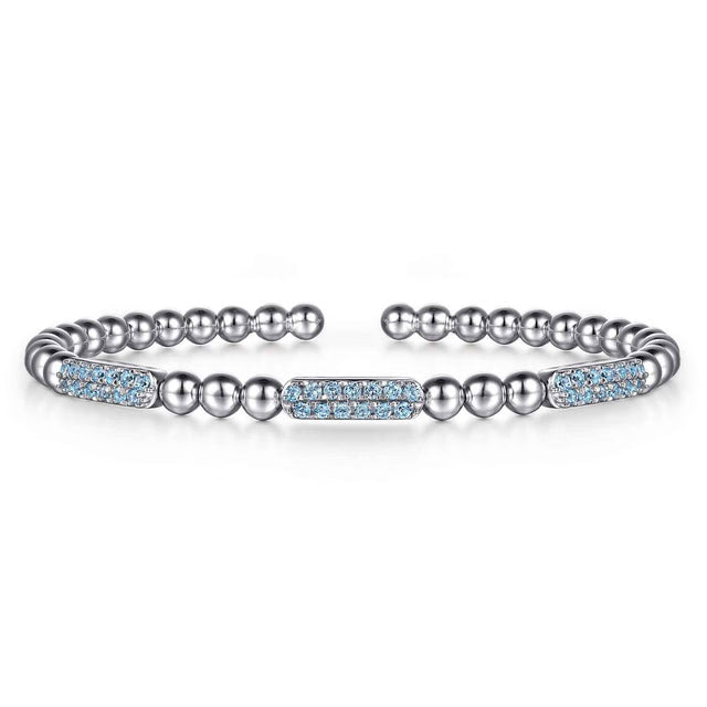 Silver bracelet with blue topax accents on a white background
