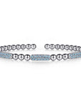 Silver bracelet with blue topax accents on a white background